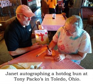 Janet autographing a hotdog bun at Tony Packo's in Toledo, Ohio.
